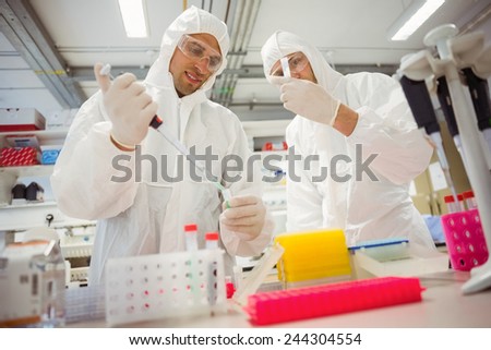 Science students working in protective suits at the university