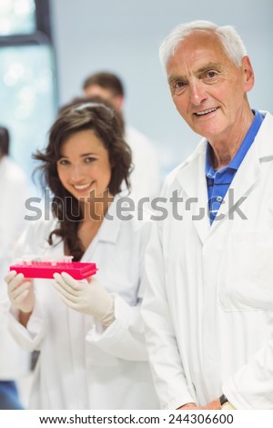 Lecturer and student smiling at camera in the lab at the university
