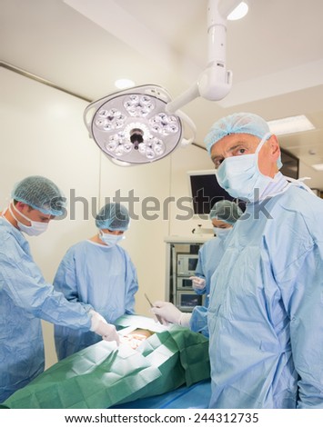 Medical student looking at camera during practice surgery at the university