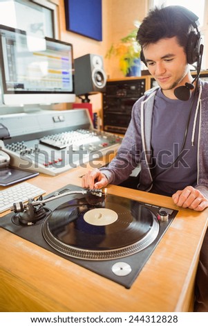 Portrait of an university student with a turn table in the studio of a radio