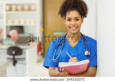 Young medical student taking notes at the university