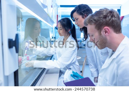 Science students using pipette in the lab at the university