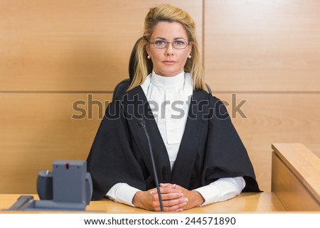 Stern judge looking at camera in the court room