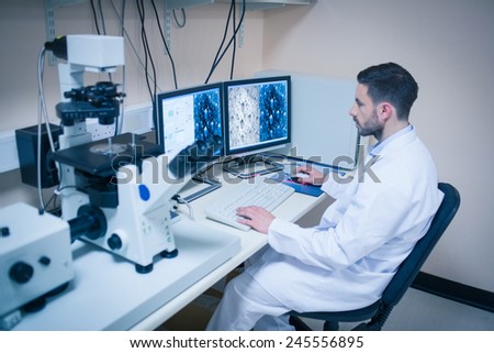 Science student looking at microscopic images at the university