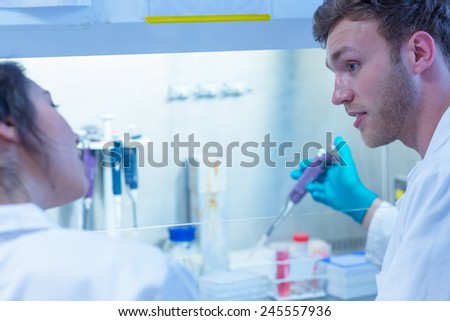 Science student using pipette in the lab at the university