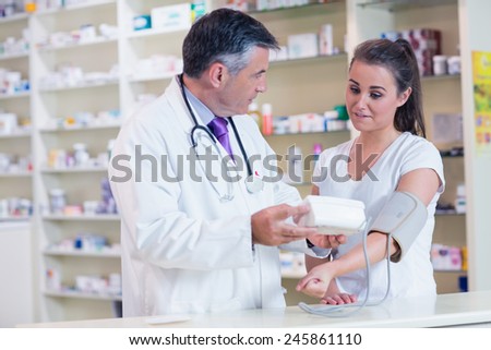 Pharmacist and patient speaking about blood pressure in the pharmacy