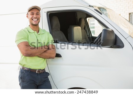 Three quarter length portrait of smiling man standing against delivery van