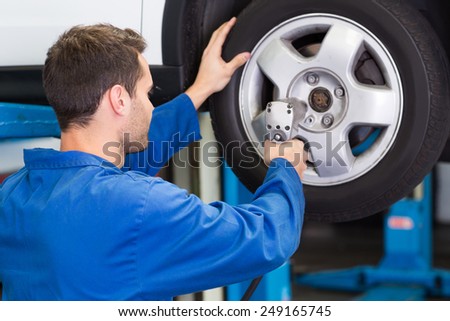 Mechanic adjusting the tire wheel at the repair garage