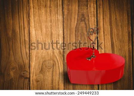 Love heart lock against wooden table