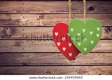 Cute heart decorations against wooden planks background