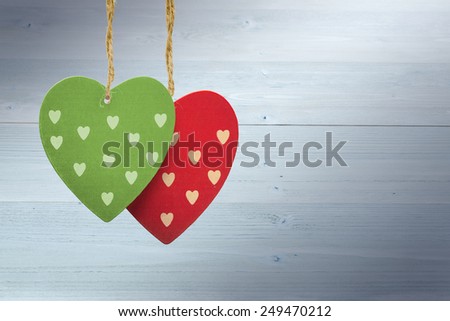 Cute heart decorations against bleached wooden planks background