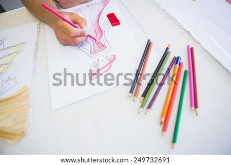 College student drawing picture with colored pencil at the college