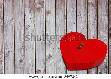 Love heart lock against digitally generated grey wooden planks
