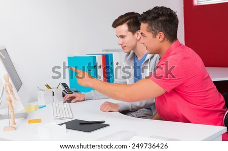 Students working together on computer at the college
