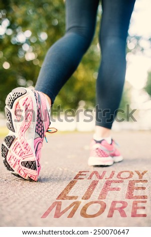 Close up picture of pink running shoes against enjoy life more