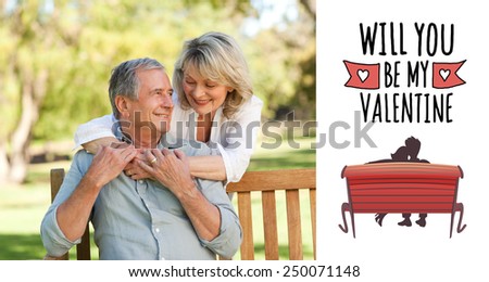 Senior woman hugging her husband who is on the bench against cute valentines message