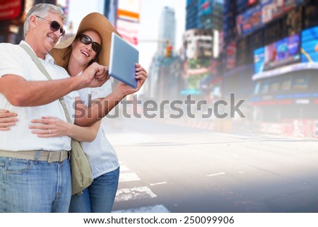 Vacationing couple taking photo against blurry new york street