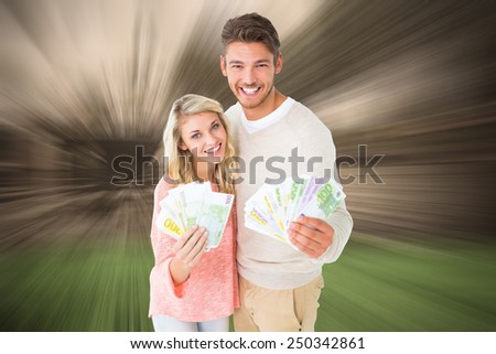 Attractive couple flashing their cash against sunny day in amsterdam