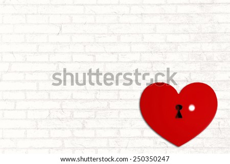 Love heart lock against white wall