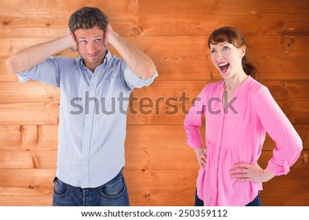 Woman arguing with ignoring man against overhead of wooden planks
