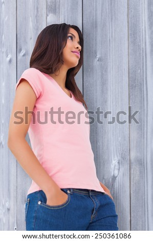 Pretty brunette stepping against bleached wooden planks background
