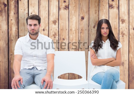 Angry couple not talking after argument against wooden planks