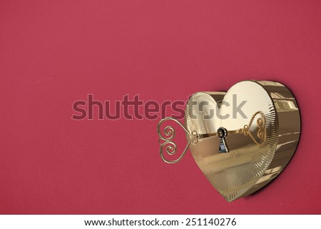 Golden heart lock against red