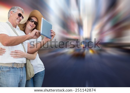 Vacationing couple taking photo against blurry new york street