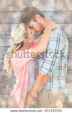 Attractive young couple about to kiss against light glowing dots design pattern