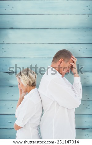 Upset couple not talking to each other after fight against wooden planks