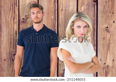 Young blonde not listening to boyfriend against wooden planks background