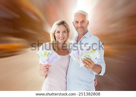 Happy couple flashing their cash against blurry new york street