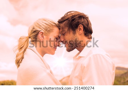 Cute smiling couple standing outside facing each other on a chilly day