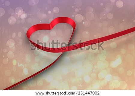 Red ribbon heart against pink abstract light spot design