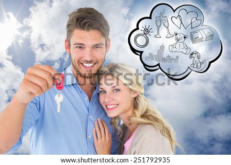 Attractive young couple showing new house key against bright blue sky with clouds