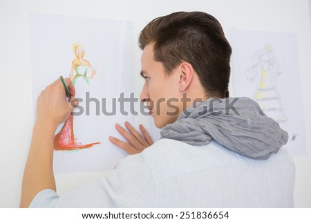 Fashion student drawing pictures on paper at the college