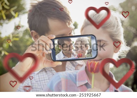 Composite of Couple taking Valentines selfie