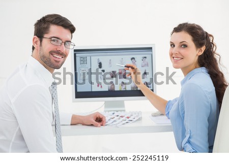 Portrait of smiling teamwork using computer in the office