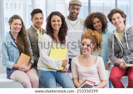 Fashion students smiling at camera together at the college