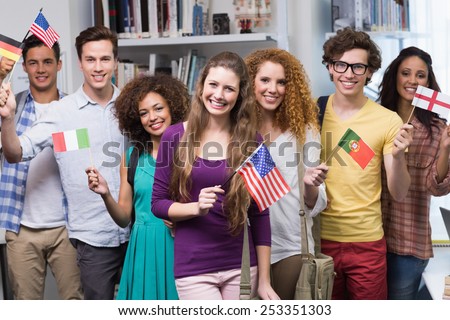 Happy students waving international flags at the college