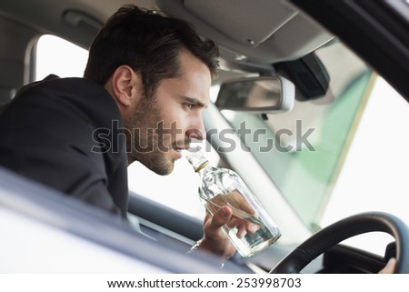 Young businessman driving while drunk in his car