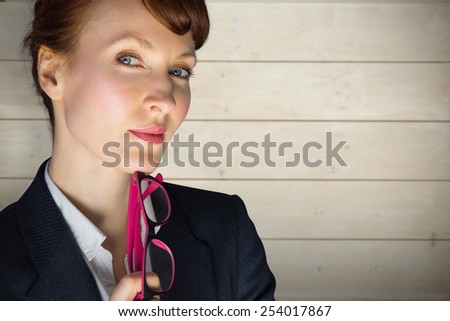 Thinking businesswoman against bleached wooden planks background