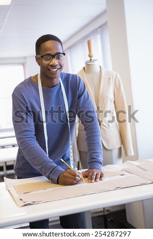 Smiling university student drawing patterns at the university