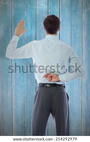 Businessman crossing fingers behind his back against wooden planks
