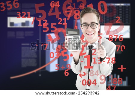 Geeky smiling businessman showing calculator against business interface with graphs and data