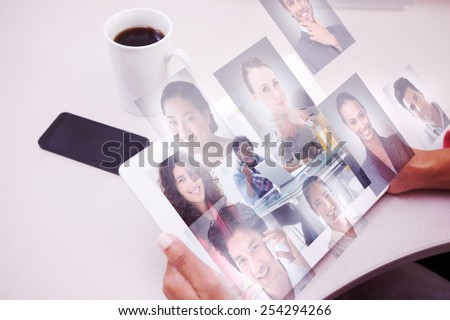 Smiling designer using tablet against profile pictures