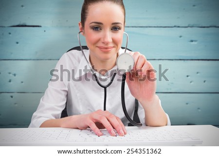 Businesswoman running computer diagnostics against painted blue wooden planks