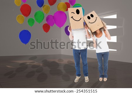 Mature couple wearing boxes over their heads against digitally generated room with bordered up window