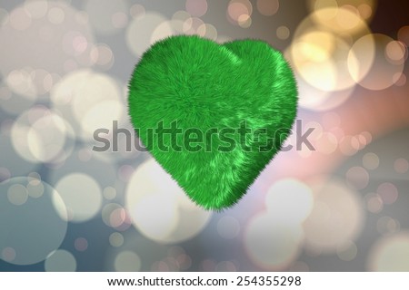 Green heart against light glowing dots design pattern