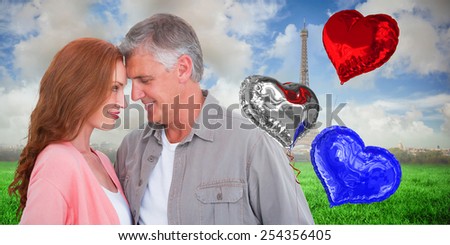 Casual couple hugging and smiling against eiffel tower